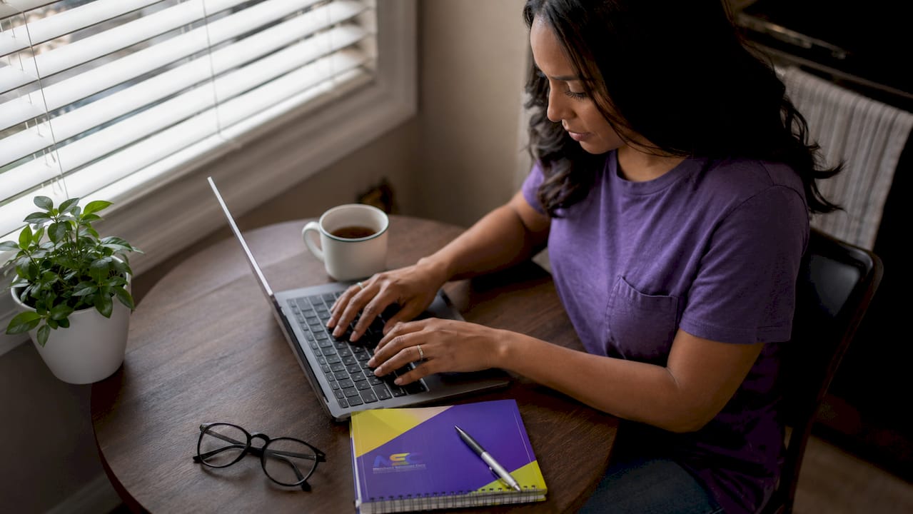 Woman entering bank info on laptop for dating ACH payment