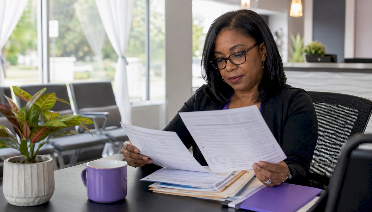 Dental receptionist reviewing payment paperwork