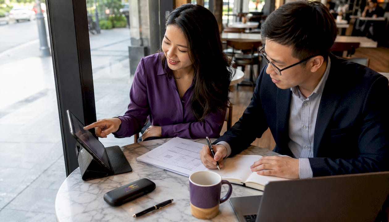 Two professionals reviewing online orders