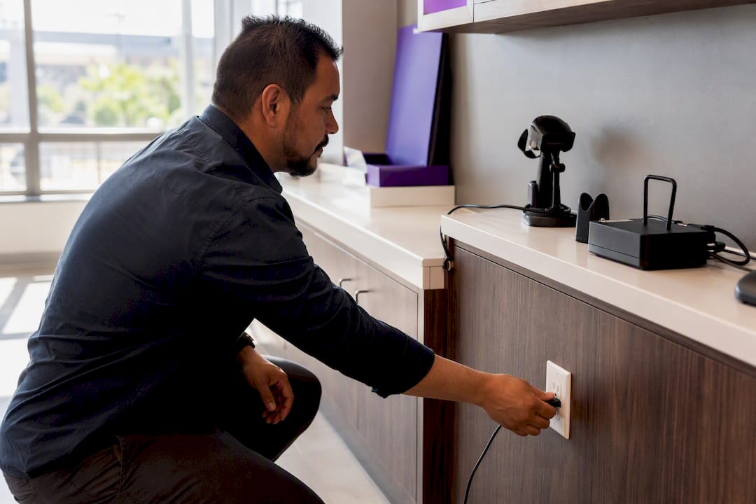 Hands connecting payment terminal cable