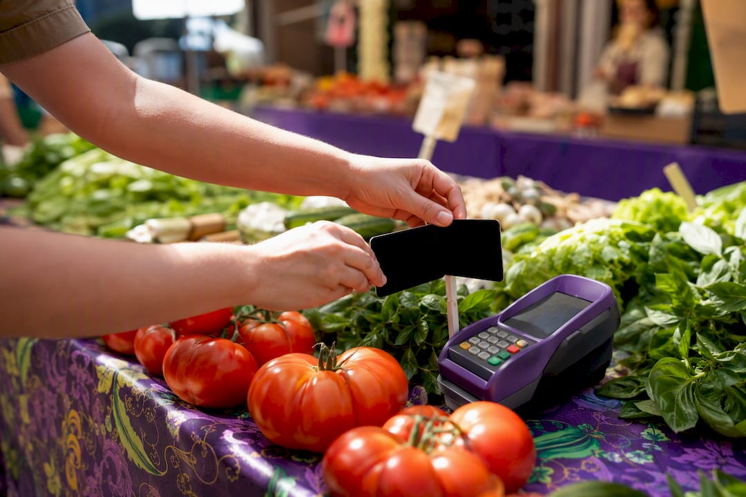 Hands adjusting dual pricing at retail counter