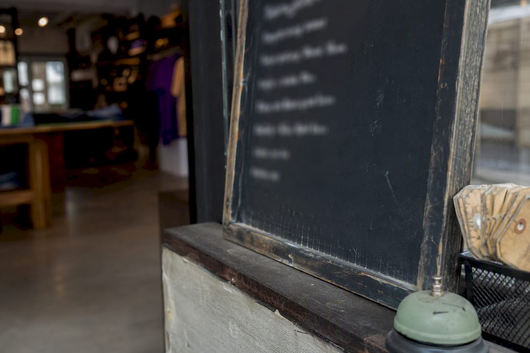Close-up of a retail store chalkboard sign about surcharging laws