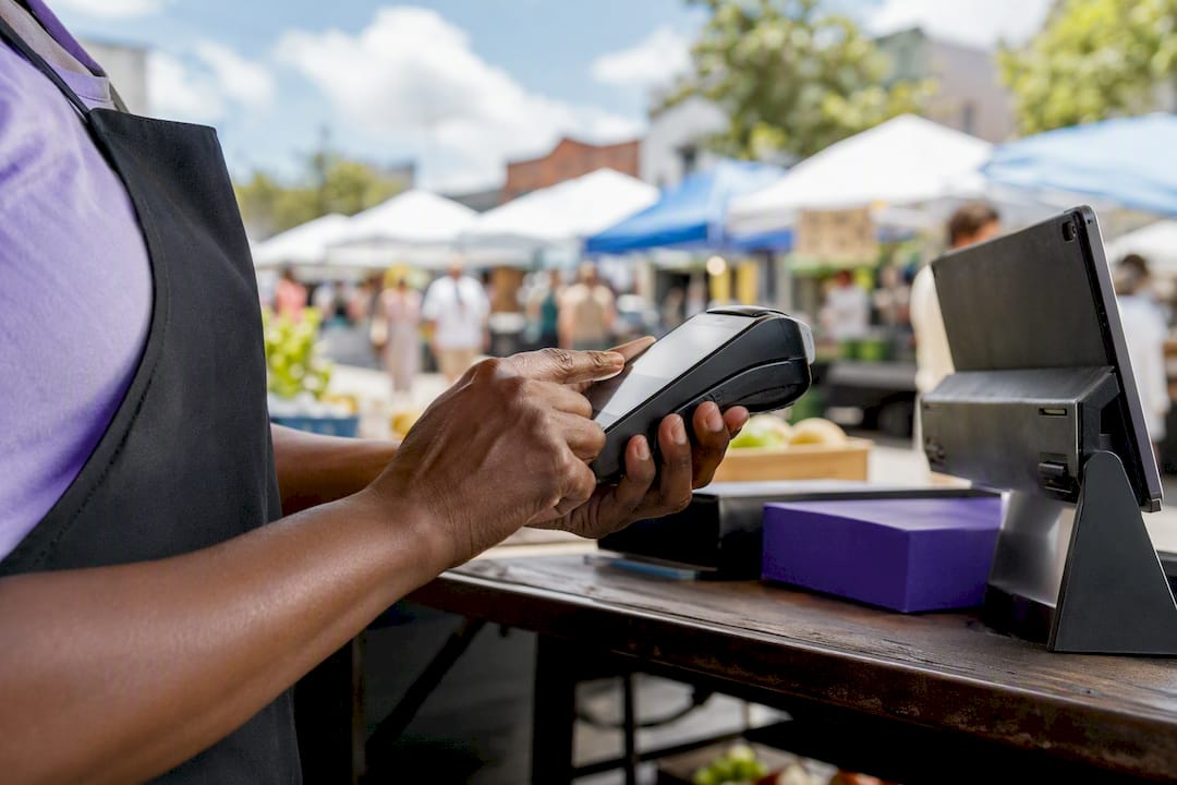 Hands adjusting payment terminal cable