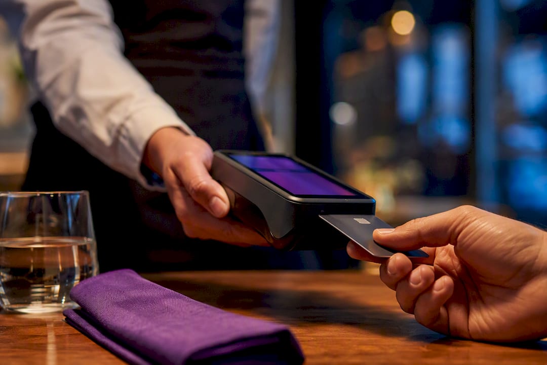 Guest completing payment at restaurant table