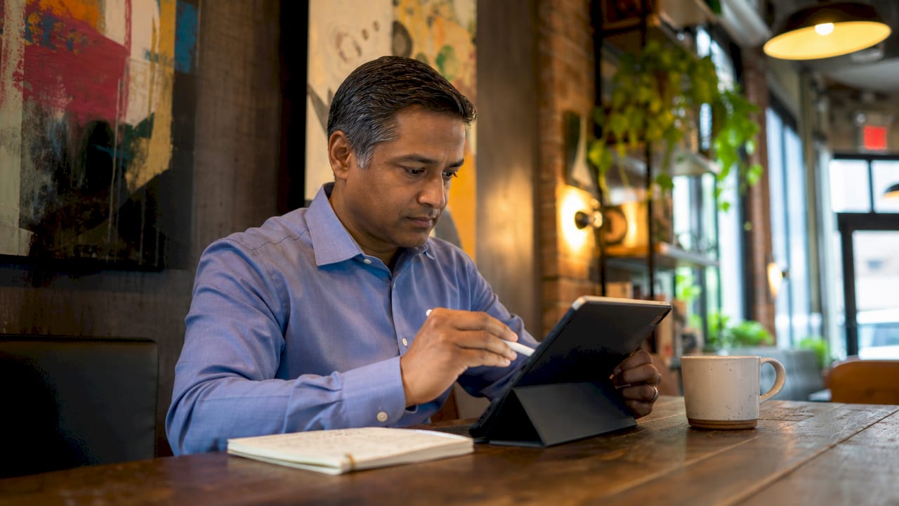 Man using tablet in home office workspace