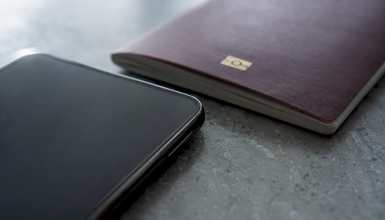 Passport and smartphone on table for NFC reading