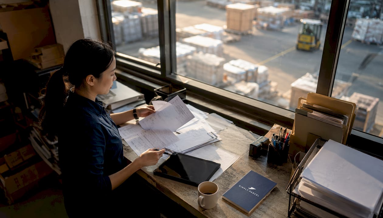 Export coordinator working on shipping documents