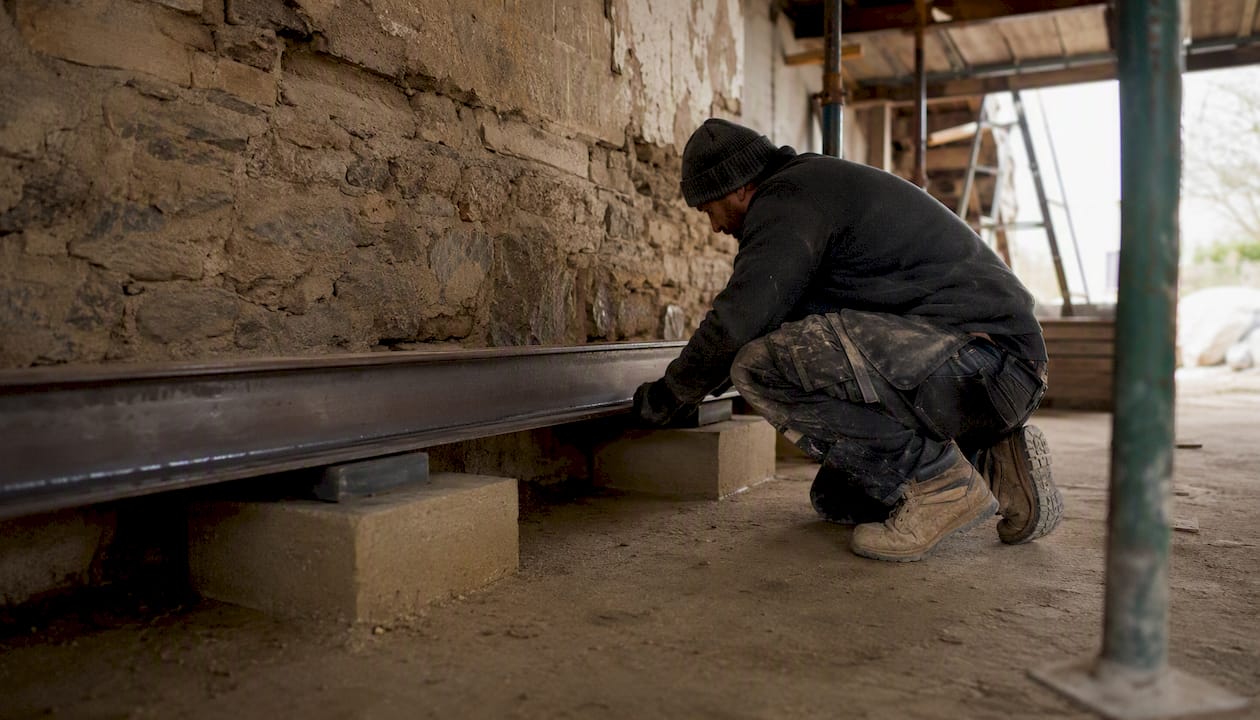 Steel beam resting on padstones at renovation site