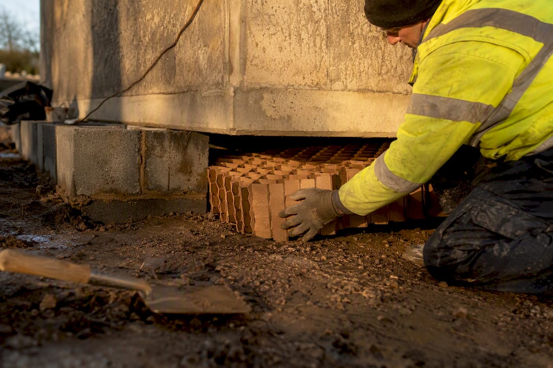 Worker installing honeycomb void former panel