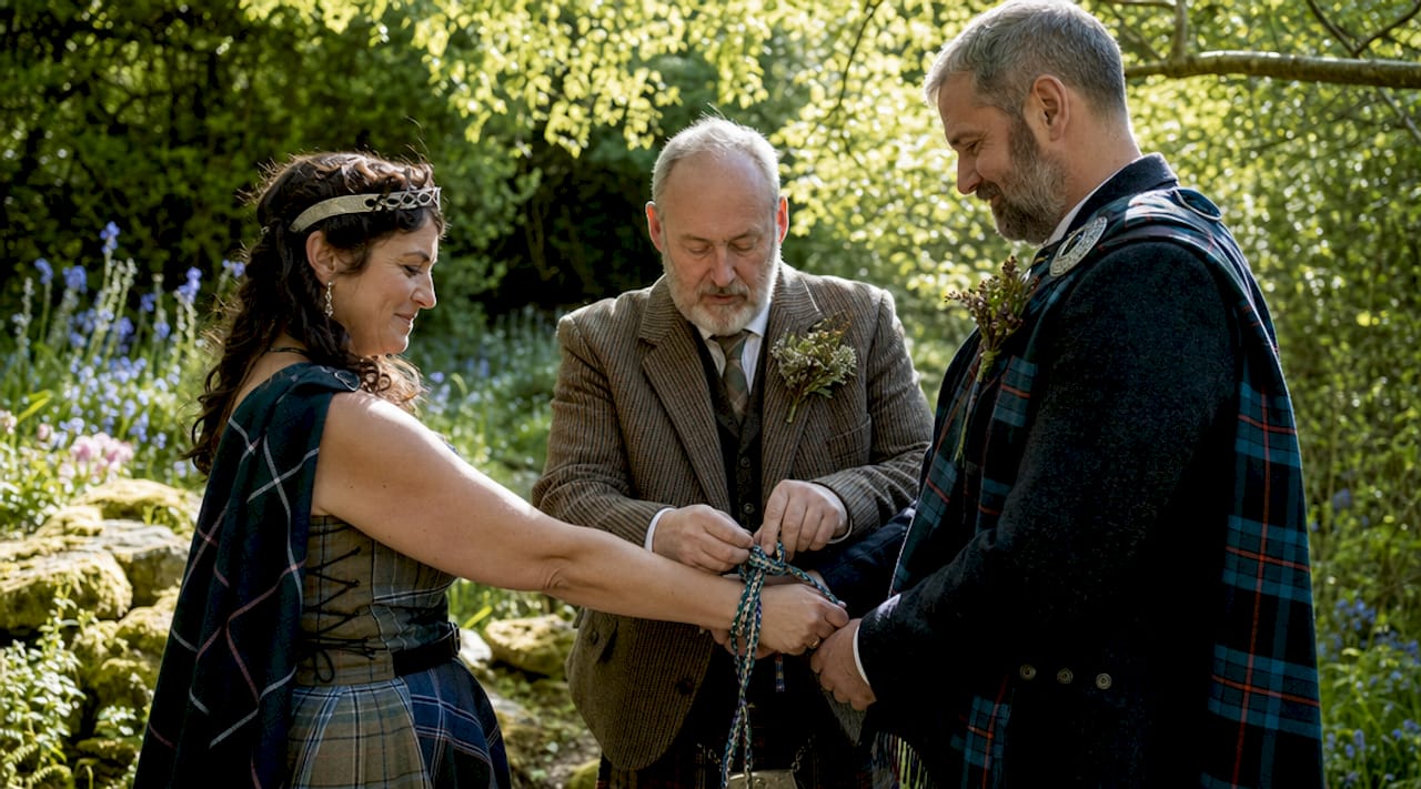 Couple handfasting in a traditional Scottish room