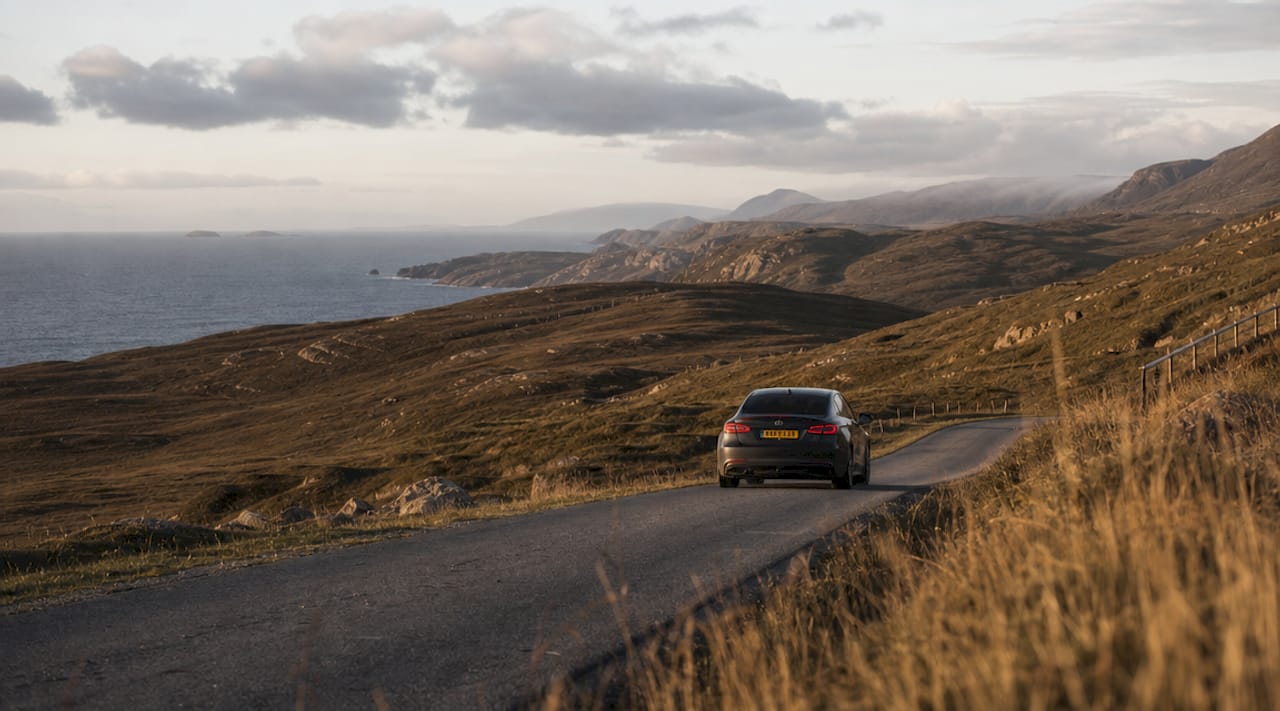 Car driving North Coast 500 coastal road