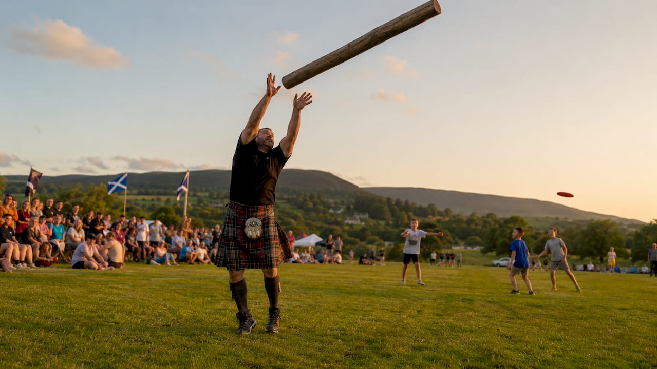 Man tossing caber at Highland Games festival