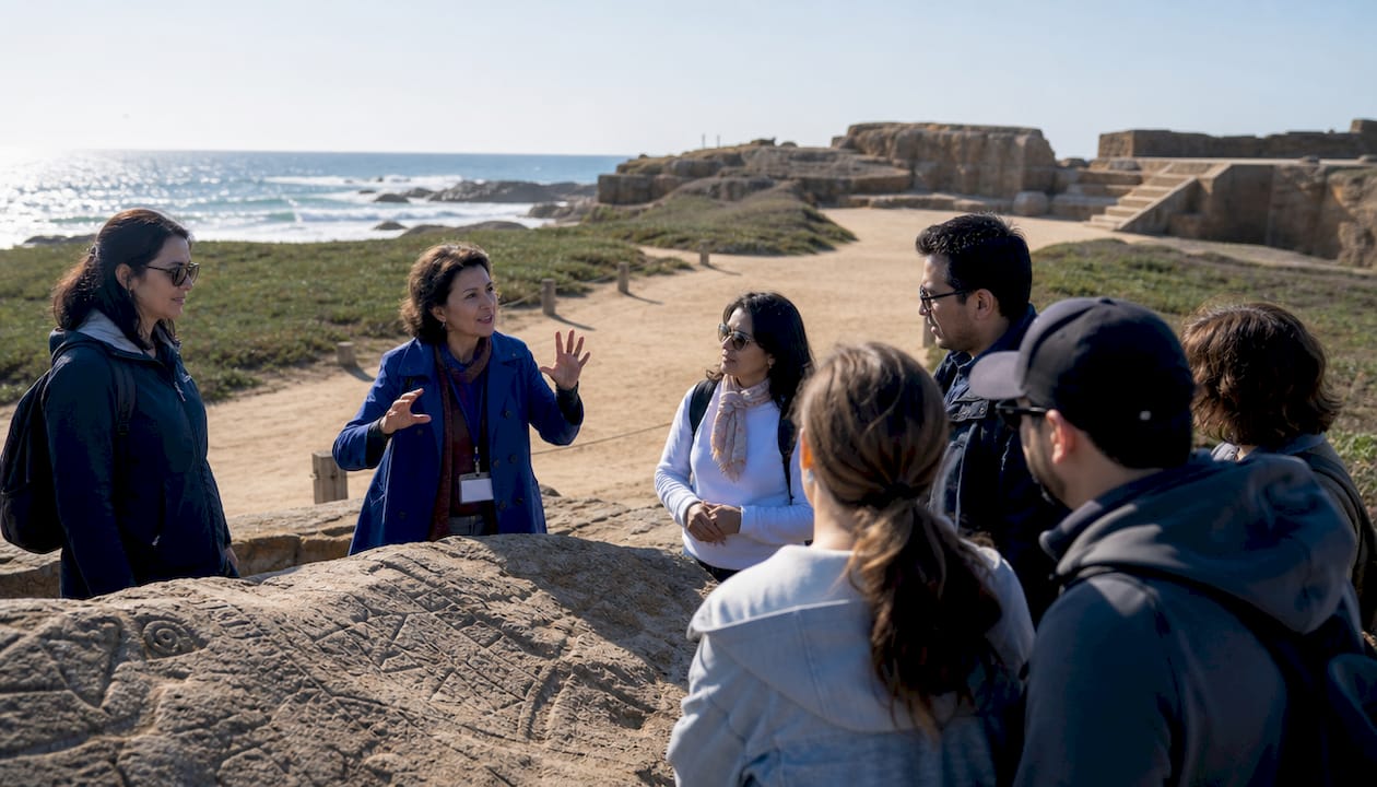 Tourists engaging with guide at historical site