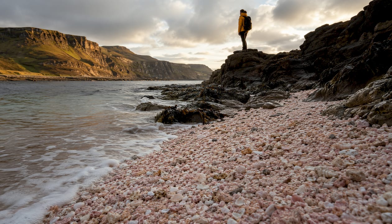 Hiker admiring Coral Beach, Isle of Skye