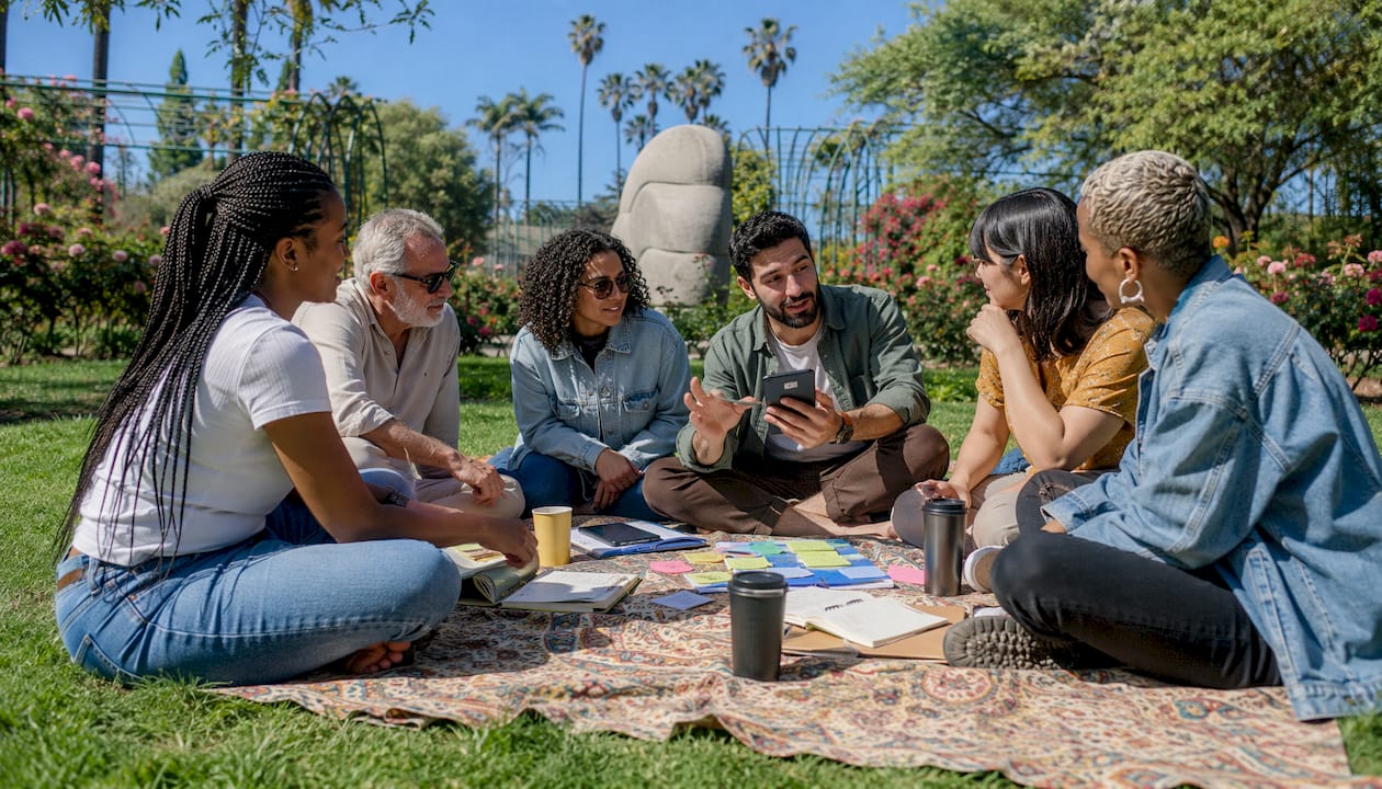 Friends discussing group trip plans outdoors