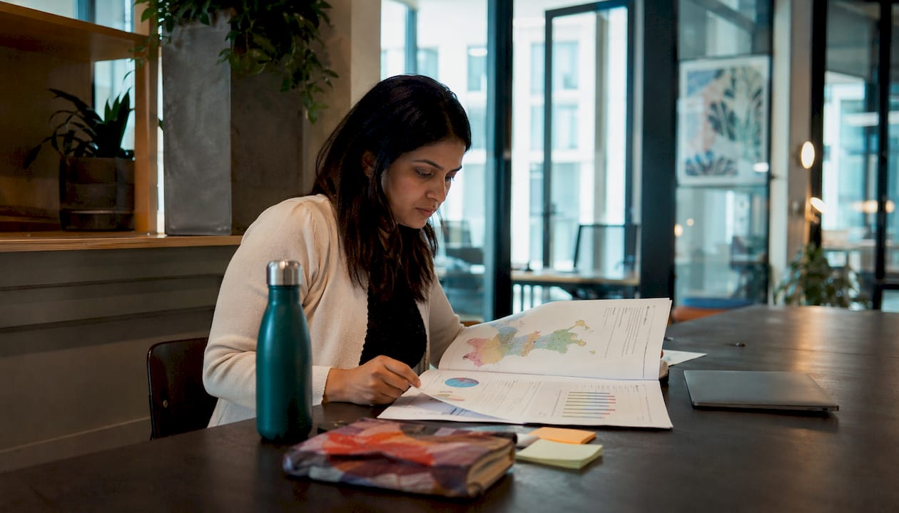 Woman reviewing seasonal tour demand report