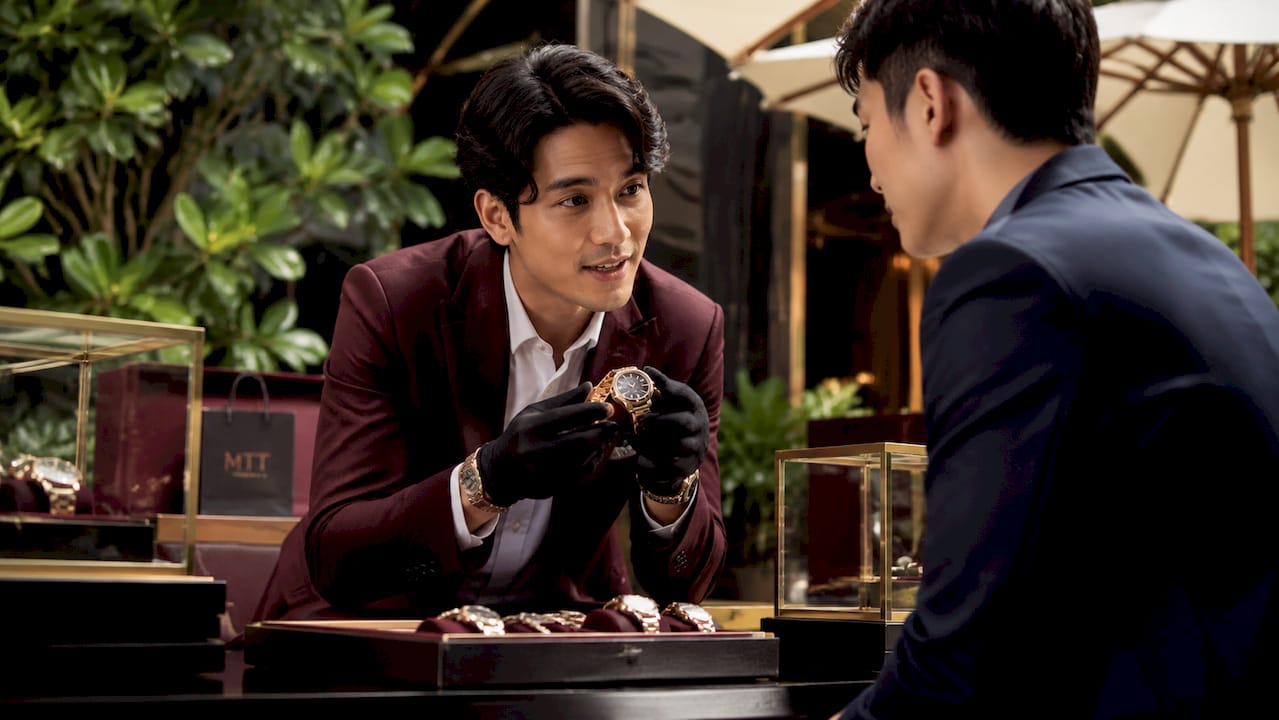 Client advisor showing luxury watch in boutique