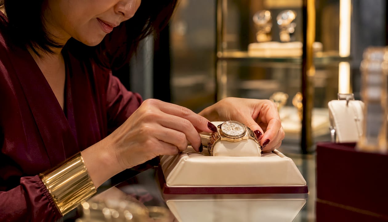 Hands adjusting luxury watch display