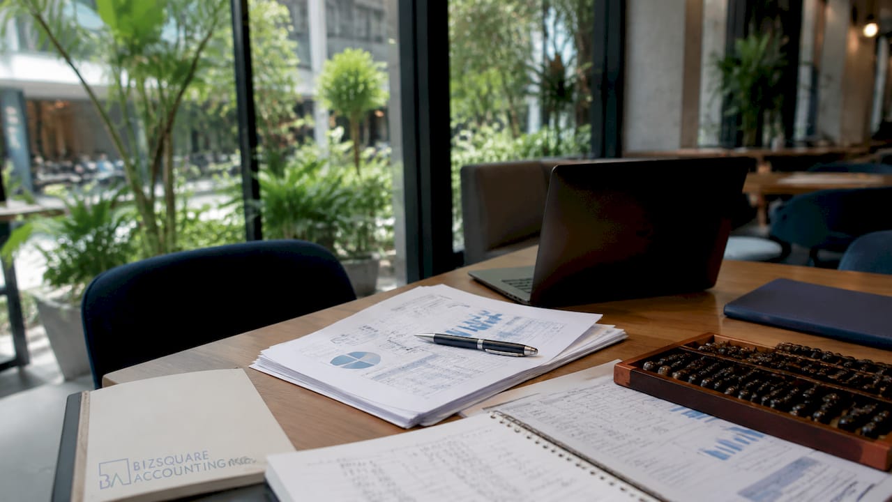 Desk with management accounts and calculator in Singapore office