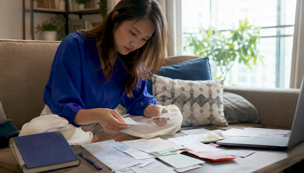 Hands organizing business records in Singapore office