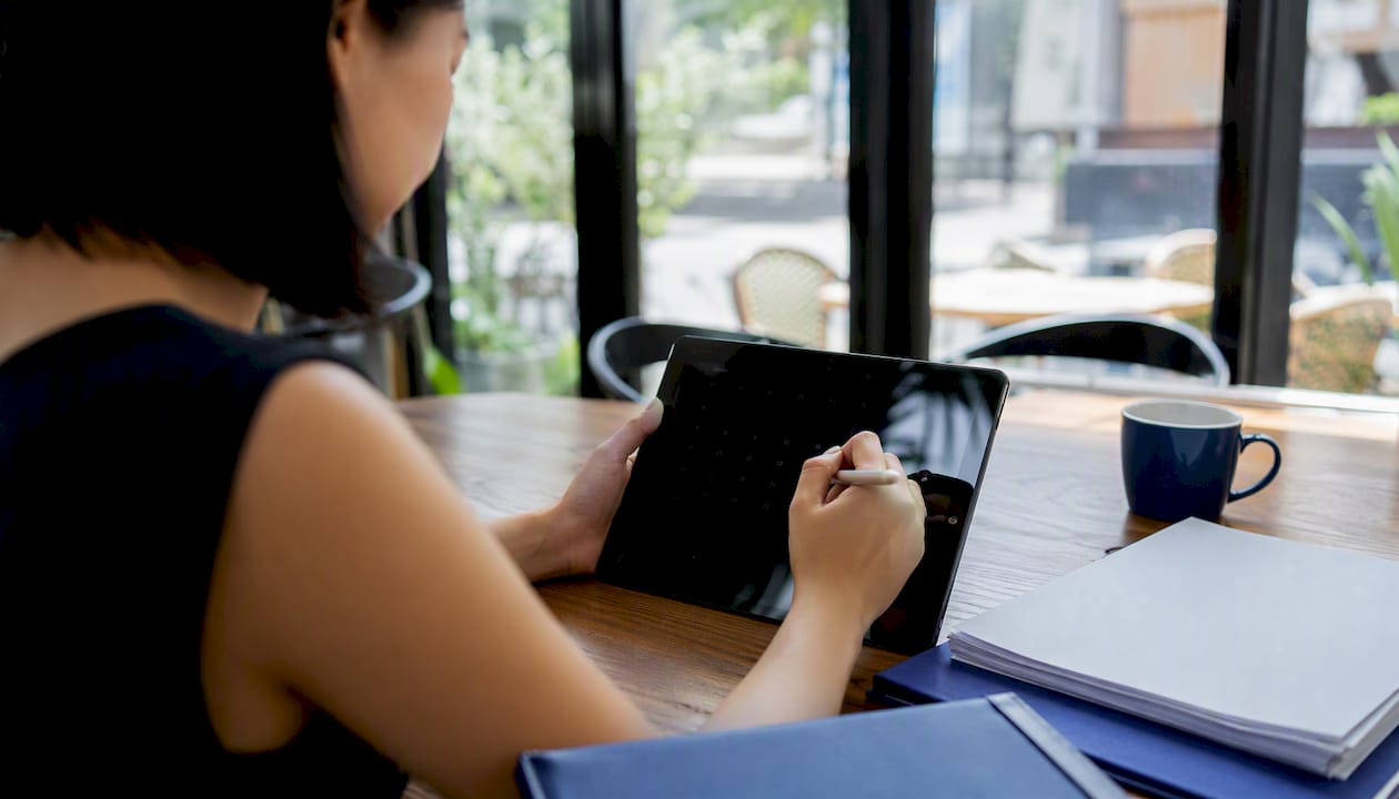 Hands managing tax filing deadline calendar on tablet