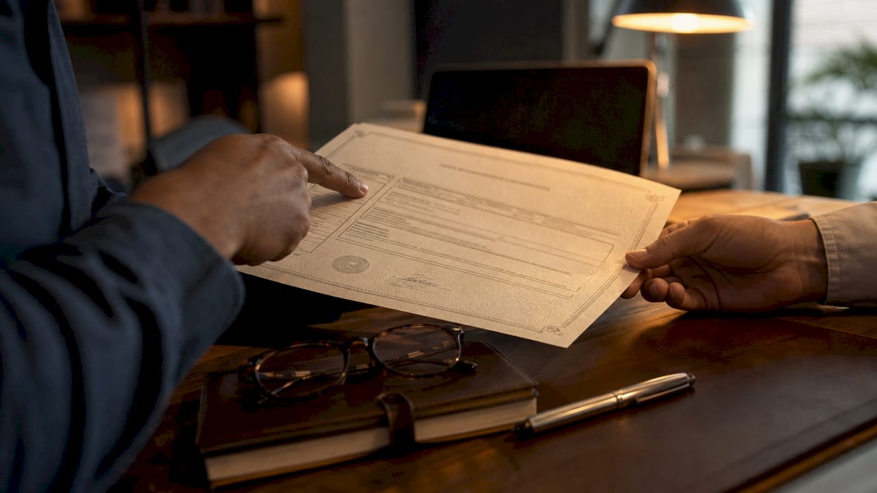 Close-up of hands examining insurance certificate