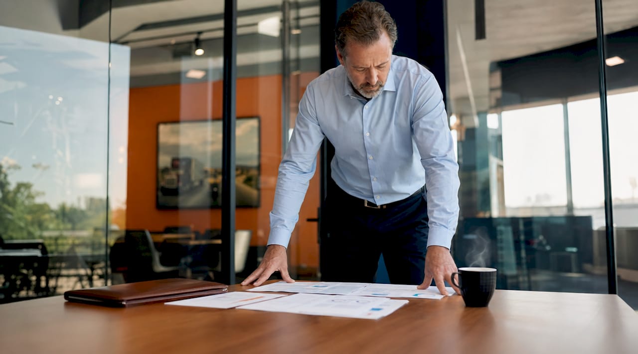 Broker reviewing trucking insurance policies