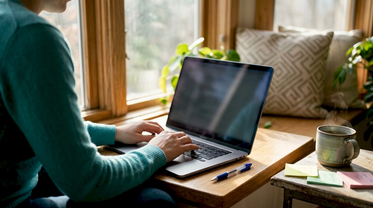 Close-up of Employment Pass application and laptop