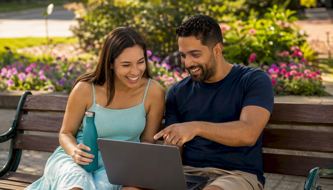 Couple browsing lifestyle event site in café
