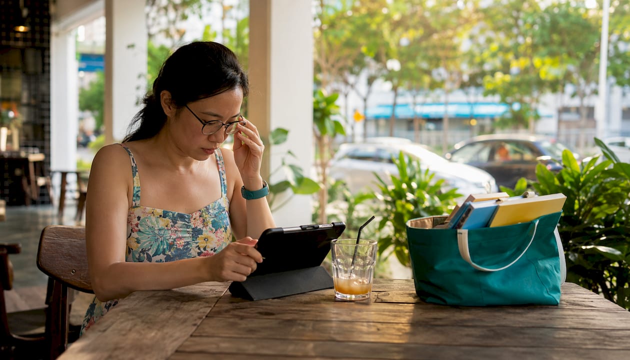 Mother researching expat activities on tablet