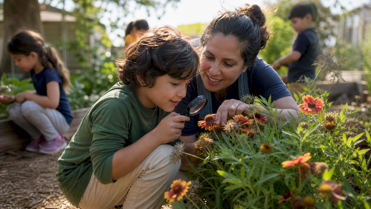 Parent volunteer assisting child on outdoor school trip