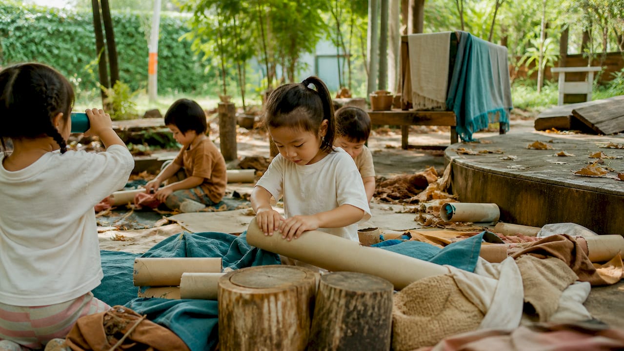 Young children playing creatively outdoors