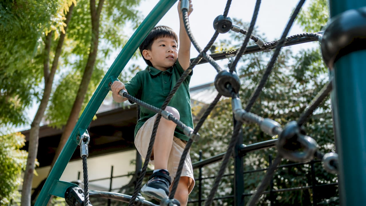 Child climbing playground challenge