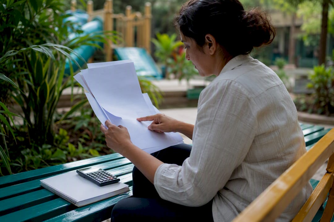 Parent comparing school fees at home desk