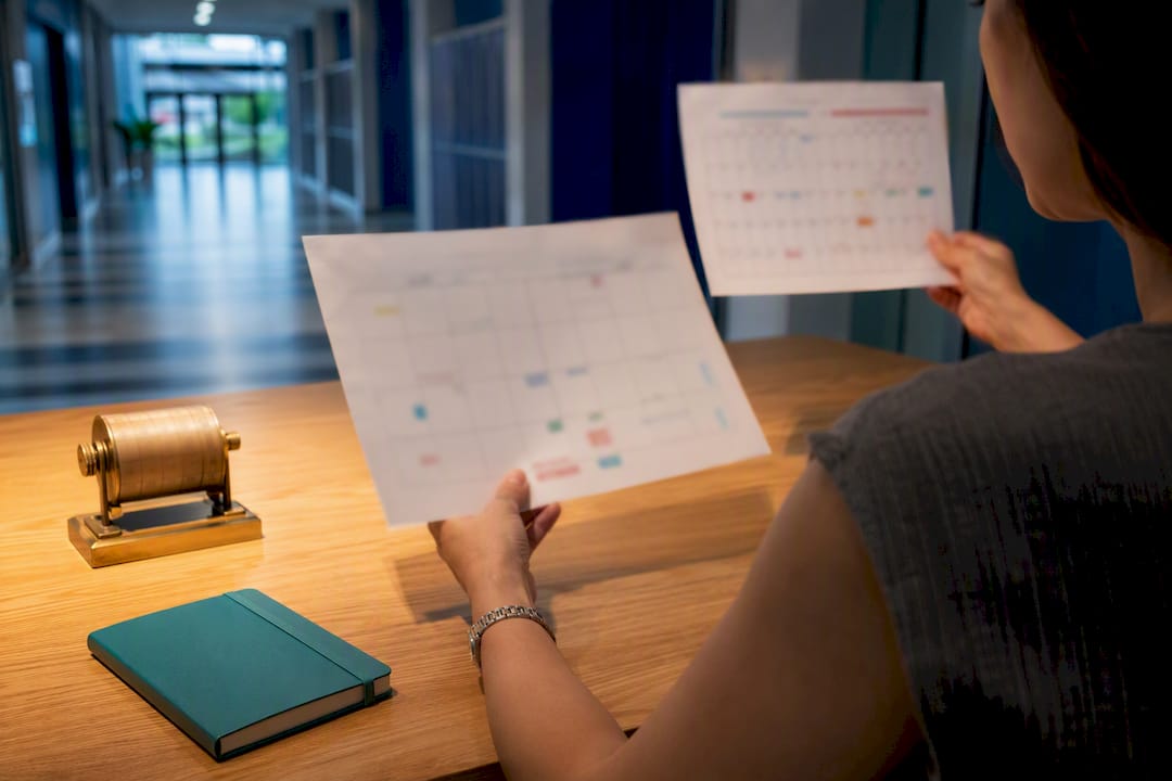 Parent comparing school calendars at home