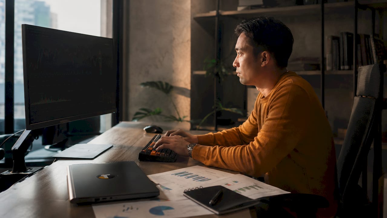 Trader analyzing market data at desk