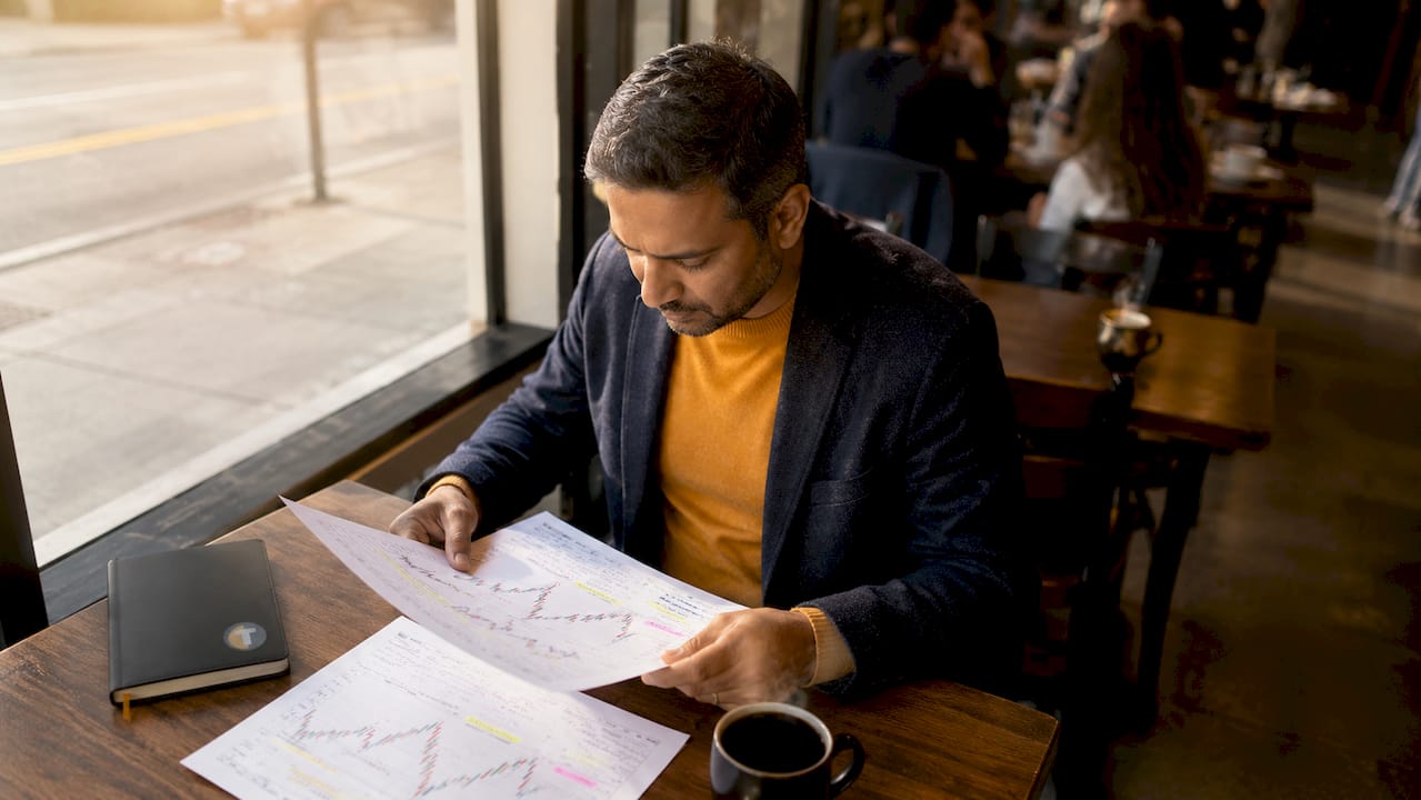 Trader reviewing printed strategy documents