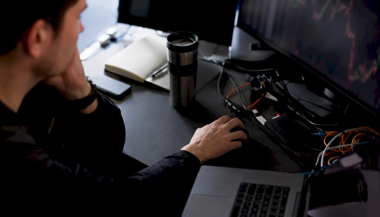Trader hands reflecting on market signals at trading desk