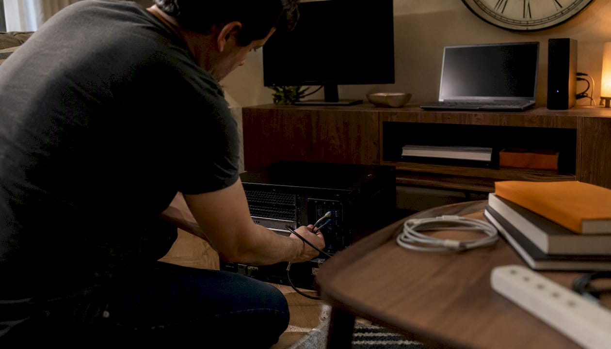 Home server setup with hands connecting cables
