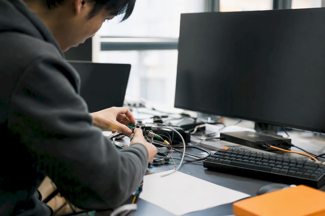 Hands adjusting trading bot hardware