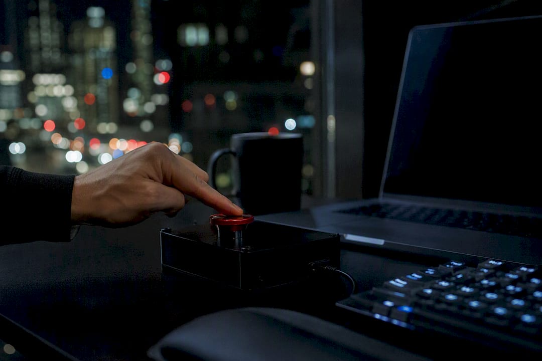 Hand pressing kill-switch button on external control device