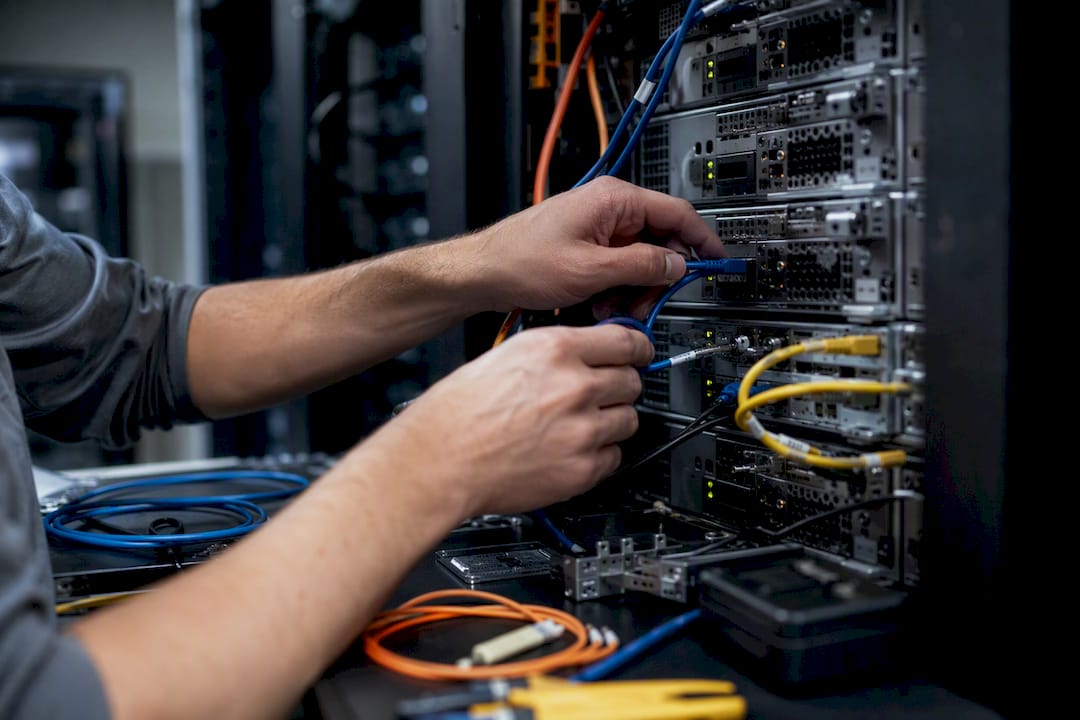 Hands connecting trading servers in data center