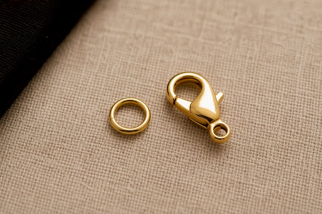 Gold chain lobster clasp and soldered jump ring close-up
