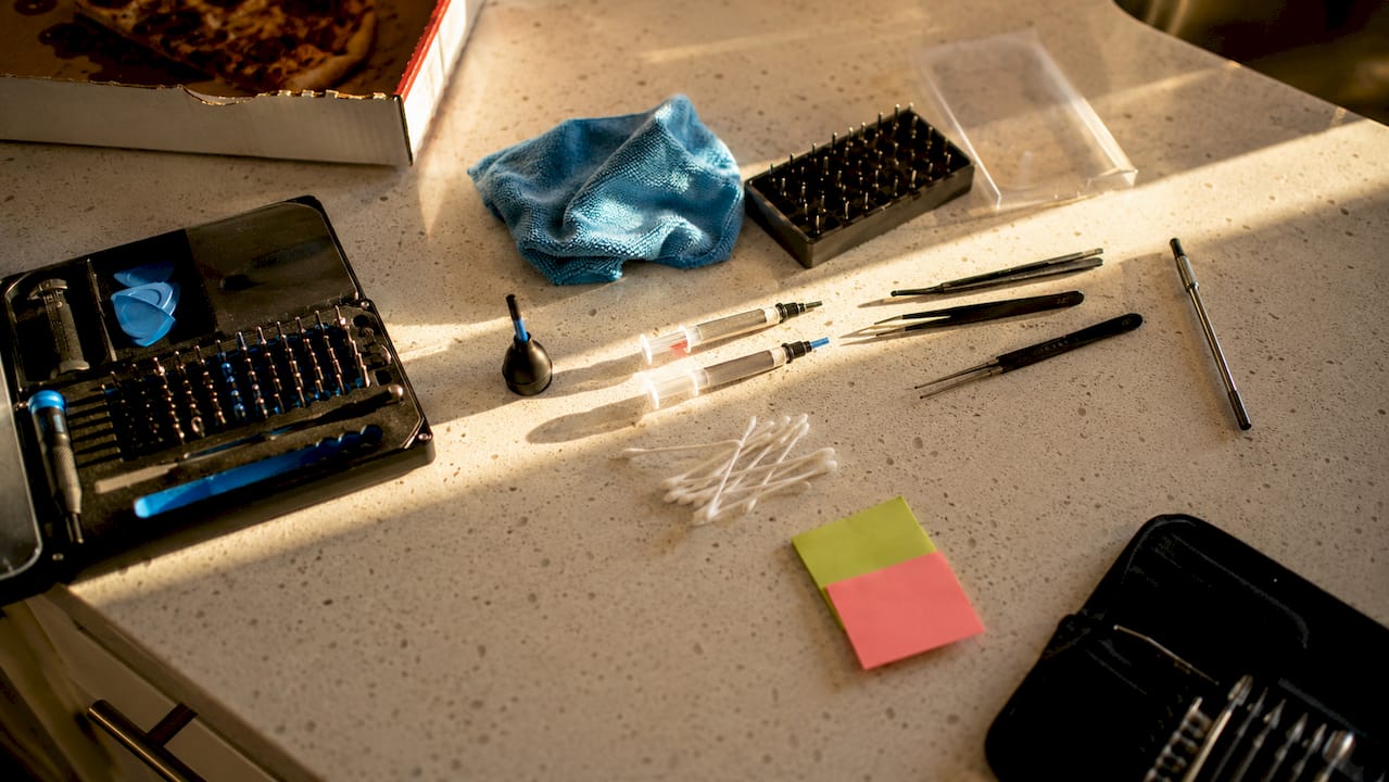 Overhead view of electronics maintenance tools on desk