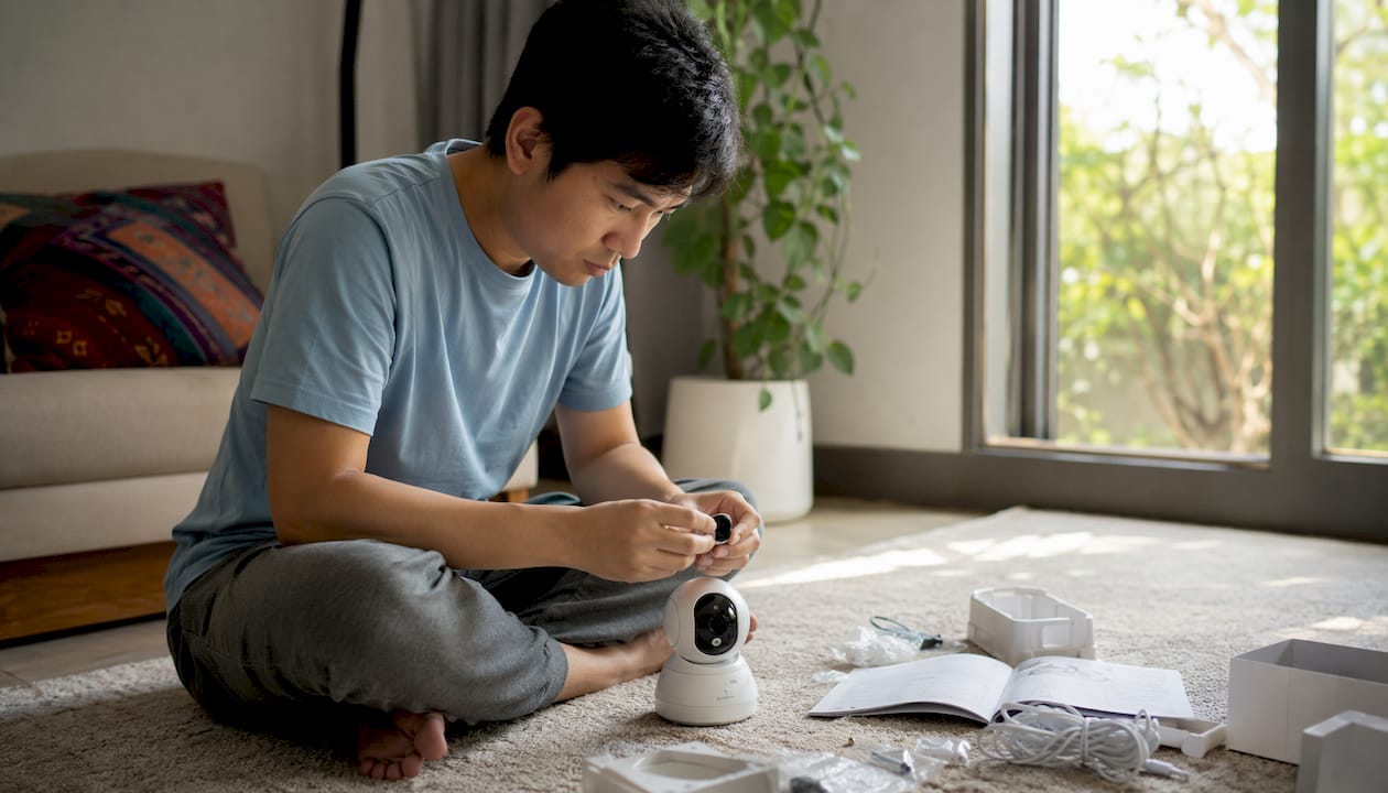 Hands assembling IP camera in home office