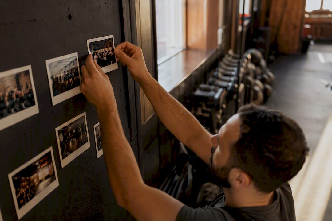 Hand attaching updated gym photo for local SEO