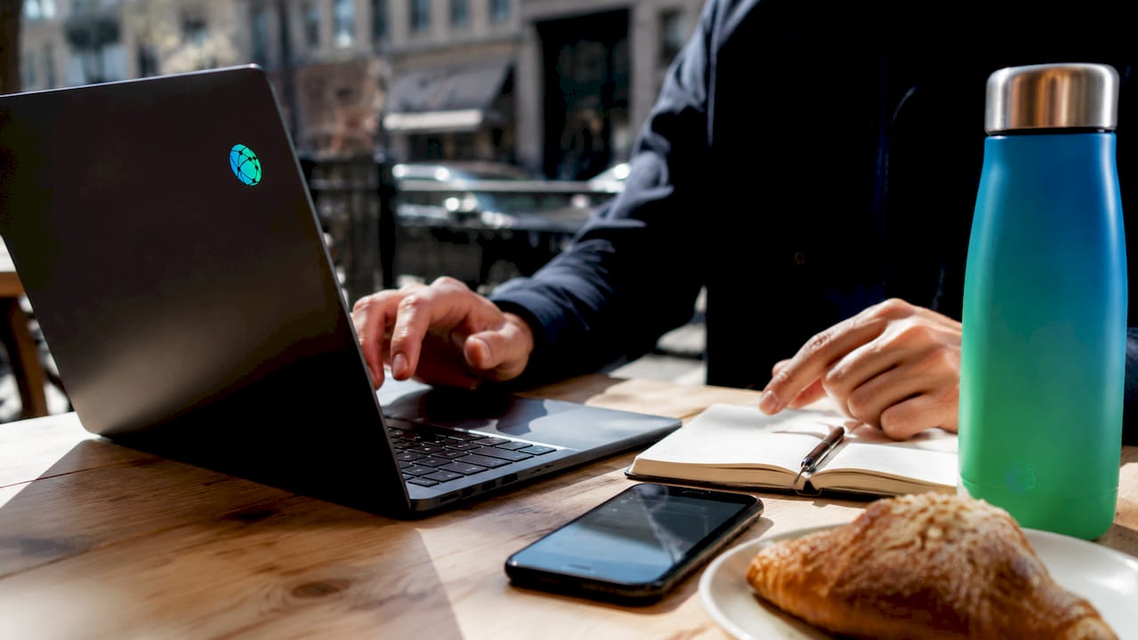 Hands pointing at UTM parameter notes next to laptop keyboard