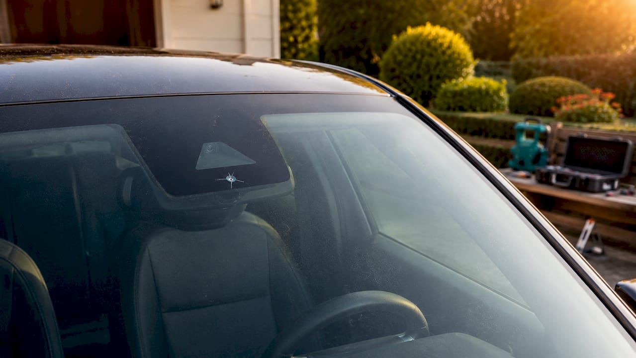 Close-up of damaged windshield and ADAS camera