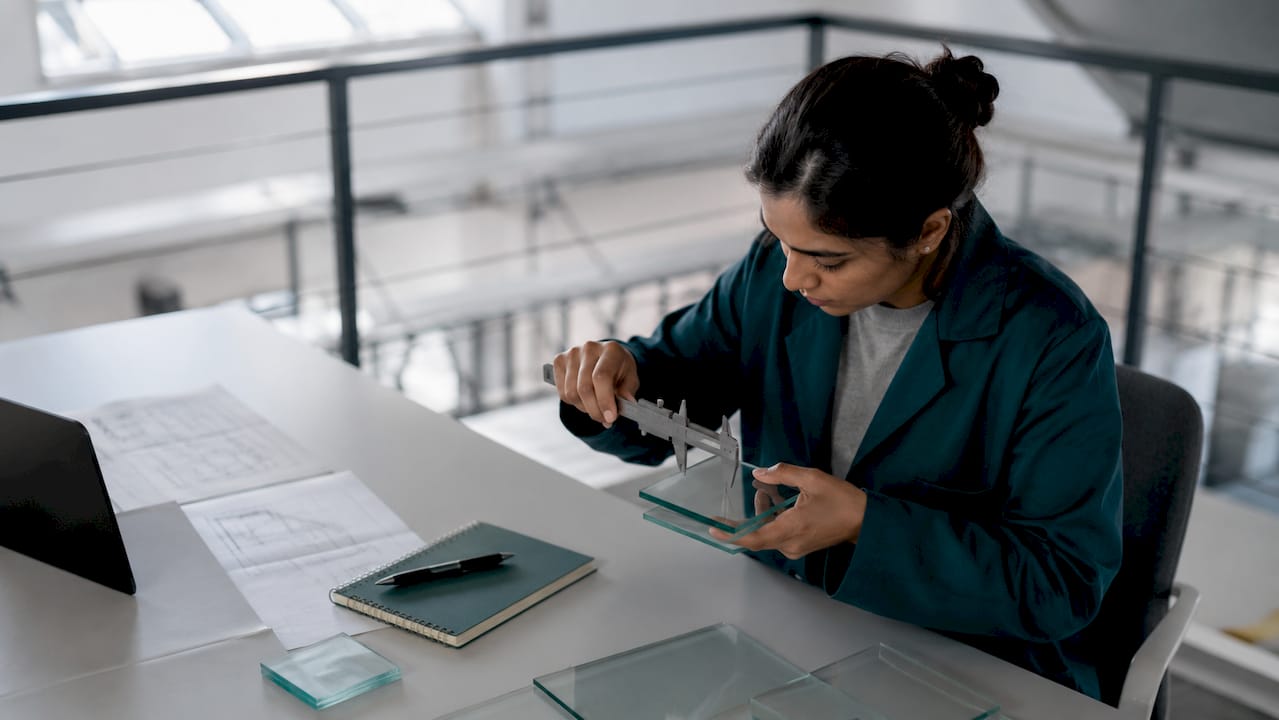 Engineer measuring touchscreen glass thickness