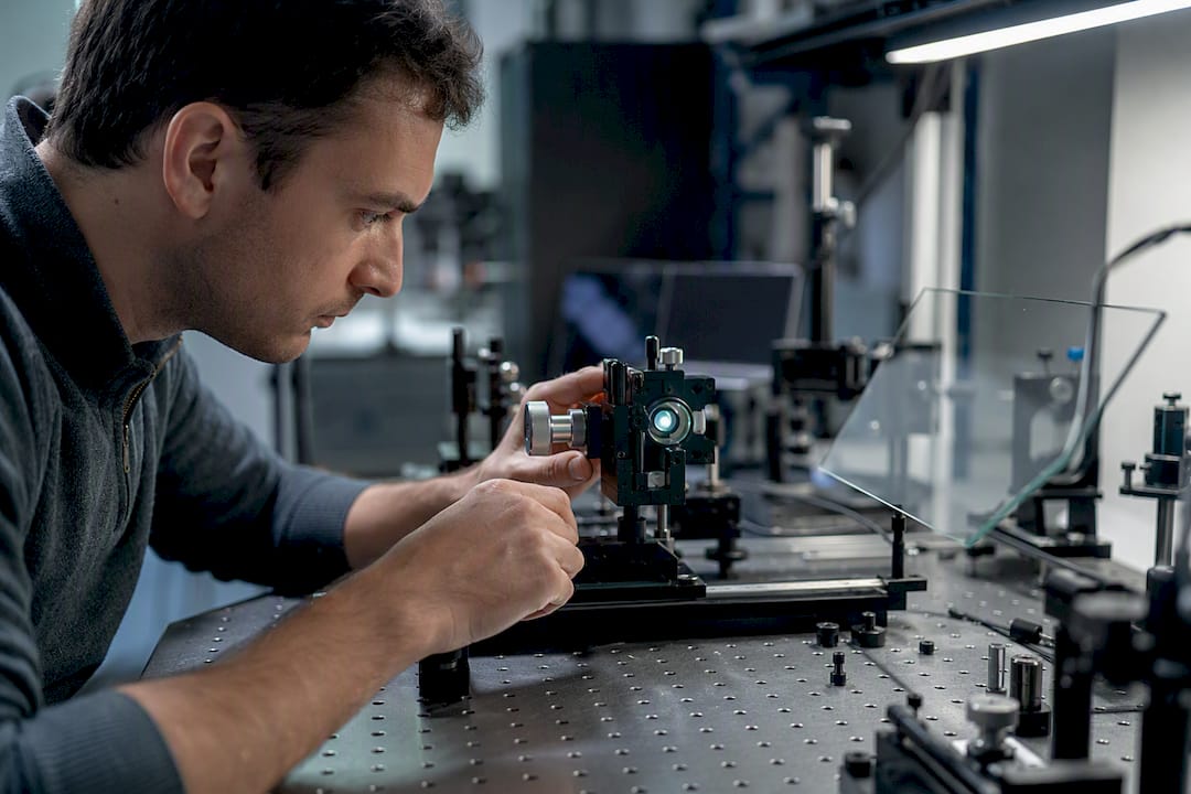 Engineer aligning projector beam at HUD combiner glass